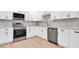 Kitchen boasting stainless steel appliances, shaker-style cabinets, and elegant hardwood floors at 333 Lake Otis Se Dr, Winter Haven, FL 33880