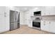 Kitchen showcasing a stainless steel refrigerator, hardwood floors, and white cabinetry at 333 Lake Otis Se Dr, Winter Haven, FL 33880
