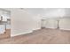 Open-concept living space with laminate flooring, neutral walls, and seamless flow to the adjacent kitchen at 333 Lake Otis Se Dr, Winter Haven, FL 33880