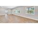 Inviting living room with laminate flooring, neutral walls, and multiple windows offering ample natural light at 333 Lake Otis Se Dr, Winter Haven, FL 33880