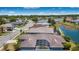An elevated view of an outdoor screened patio that overlooks a tranquil lake in a desirable neighborhood at 3374 Waterlute Way, Lakeland, FL 33811
