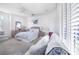 Comfortable bedroom with white walls, soft carpet, and large shuttered windows at 3374 Waterlute Way, Lakeland, FL 33811
