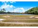 View of common area with tennis and basketball courts, playground, and cornhole games at 3374 Waterlute Way, Lakeland, FL 33811