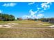 Cornhole game setup on the lawn near the lake at 3374 Waterlute Way, Lakeland, FL 33811