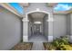 Grand covered entrance features a welcome door, gray paint, and an archway for a welcoming arrival at 3374 Waterlute Way, Lakeland, FL 33811