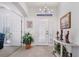 Elegant foyer with tiled floors, a decorative light fixture, and a front door with sidelights at 3374 Waterlute Way, Lakeland, FL 33811