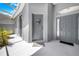 Inviting covered entryway featuring a gray front door with a decorative wreath and welcome mat at 3374 Waterlute Way, Lakeland, FL 33811