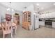 An open-concept kitchen and dining room with stainless steel appliances, a chandelier, and bright white cabinetry at 3374 Waterlute Way, Lakeland, FL 33811