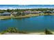 Scenic view of a serene lake surrounded by houses in the community, showcasing the community's natural beauty at 3374 Waterlute Way, Lakeland, FL 33811
