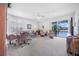 Bright living room with plush carpet, neutral decor, and sliding doors to the outdoors at 3374 Waterlute Way, Lakeland, FL 33811