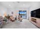 Bright living room featuring comfortable seating, a ceiling fan, and a sliding glass door with a lake view at 3374 Waterlute Way, Lakeland, FL 33811