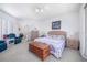 Bright main bedroom features a bed with floral bedding, shuttered windows, a ceiling fan, and carpeted floors at 3374 Waterlute Way, Lakeland, FL 33811