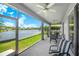 Screened in patio with ceiling fans overlooking a lake at 3374 Waterlute Way, Lakeland, FL 33811