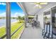 Screened in patio with ceiling fans overlooking a lake at 3374 Waterlute Way, Lakeland, FL 33811