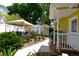 Beautiful backyard showcasing the lush greenery, a covered outdoor seating area, and the guest house at 418 E 10Th Ave, Mount Dora, FL 32757