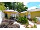 Landscaped backyard featuring covered seating, guest house, and lovely walkway at 418 E 10Th Ave, Mount Dora, FL 32757
