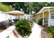 Well-manicured backyard featuring a patio, furniture, and lush landscaping at 418 E 10Th Ave, Mount Dora, FL 32757