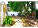 Serene backyard featuring a fire pit area, lush landscaping, and mature trees for relaxing outdoors at 418 E 10Th Ave, Mount Dora, FL 32757