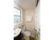 Bright bathroom with floral shower curtain, vanity, and toilet near a window at 418 E 10Th Ave, Mount Dora, FL 32757
