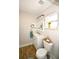 Bright bathroom featuring modern vanity with sink, medicine cabinet, and wood-look tile flooring at 418 E 10Th Ave, Mount Dora, FL 32757
