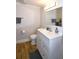 Bright bathroom featuring a white vanity with chrome fixtures, wood look flooring, and a modern toilet at 418 E 10Th Ave, Mount Dora, FL 32757