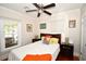 Cozy bedroom featuring a ceiling fan, a window letting in natural light, and hardwood floors at 418 E 10Th Ave, Mount Dora, FL 32757