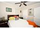 A well-lit bedroom features a modern ceiling fan, and is adorned with colorful artwork at 418 E 10Th Ave, Mount Dora, FL 32757