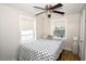 Comfortable bedroom with two windows allowing natural light to brighten the room at 418 E 10Th Ave, Mount Dora, FL 32757