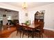 Classic dining room with hardwood floors, decorative chandelier, and an adjacent living area offers comfortable home living at 418 E 10Th Ave, Mount Dora, FL 32757