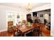 Bright dining room with hardwood floors and an open view to the living room at 418 E 10Th Ave, Mount Dora, FL 32757