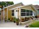 Close-up of bungalow with well-manicured landscaping and flower pots at 418 E 10Th Ave, Mount Dora, FL 32757