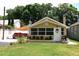 Charming home showcasing a lush green lawn, front yard landscaping, and ample parking at 418 E 10Th Ave, Mount Dora, FL 32757