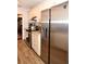 Kitchen features stainless steel appliances, granite countertops, and white cabinets with wood-look tile flooring at 418 E 10Th Ave, Mount Dora, FL 32757