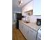 Charming kitchen featuring granite counters, white cabinets, and stainless sink and appliances at 418 E 10Th Ave, Mount Dora, FL 32757