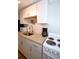 Charming kitchen featuring granite counters, white cabinets, and stainless sink and appliances at 418 E 10Th Ave, Mount Dora, FL 32757