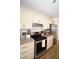 Modern kitchen featuring granite counters, stainless steel appliances, and functional layout at 418 E 10Th Ave, Mount Dora, FL 32757