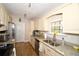 Bright kitchen with stone countertops, stainless steel appliances, and practical layout at 418 E 10Th Ave, Mount Dora, FL 32757