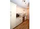 Well-lit kitchen featuring white cabinets, granite countertops, stainless steel appliances, and wood-look tile flooring at 418 E 10Th Ave, Mount Dora, FL 32757