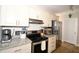 Stylish kitchen featuring light countertops, stainless steel appliances, and ample cabinetry at 418 E 10Th Ave, Mount Dora, FL 32757