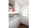 Functional laundry room equipped with washer, dryer, storage, and access to an exterior door at 418 E 10Th Ave, Mount Dora, FL 32757
