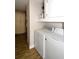 Convenient laundry area with washer, dryer, overhead storage, and wood-look tile flooring at 418 E 10Th Ave, Mount Dora, FL 32757