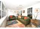Bright living room featuring comfortable seating, large windows, and modern lighting at 418 E 10Th Ave, Mount Dora, FL 32757