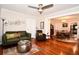 Cozy living room features hardwood floors, comfortable seating, and an open layout to the dining area at 418 E 10Th Ave, Mount Dora, FL 32757