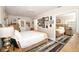 Bedroom featuring mirrored closet, hardwood floors with area rug, and collection of art on the wall at 418 E 10Th Ave, Mount Dora, FL 32757