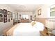 Spacious bedroom showcasing hardwood floors, an area rug and a collection of framed photos adorning the walls at 418 E 10Th Ave, Mount Dora, FL 32757