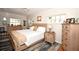 Bright bedroom showcasing natural wood furniture, hardwood floors, and large windows for ample natural light at 418 E 10Th Ave, Mount Dora, FL 32757