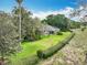 Overhead shot of a well-kept backyard with expansive lawn and lovely landscaping along the property line at 42 Grenewood Ln, Haines City, FL 33844