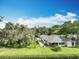 Lush backyard featuring an attractive patio, well-maintained lawn, and shade trees, offering a serene outdoor space at 42 Grenewood Ln, Haines City, FL 33844