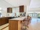 Home bar area with sink, wine storage, mirrored bar back, and barstools at 42 Grenewood Ln, Haines City, FL 33844