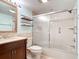 Bathroom featuring stylish wood cabinets, a bathtub, and a shower with sliding glass doors at 42 Grenewood Ln, Haines City, FL 33844